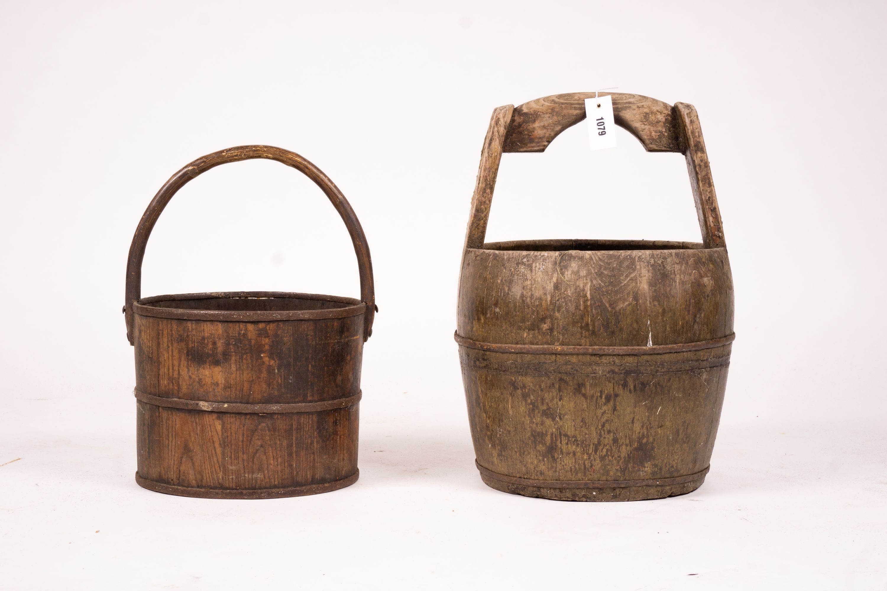 A Chinese staved wood rice carrier together with a circular iron bound staved wood bucket, larger 35cm diameter, height 52cm